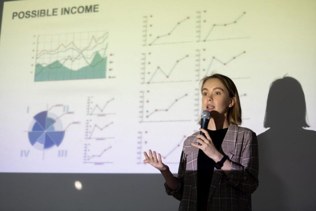 Speaker presenting revenue projections at an industry conference