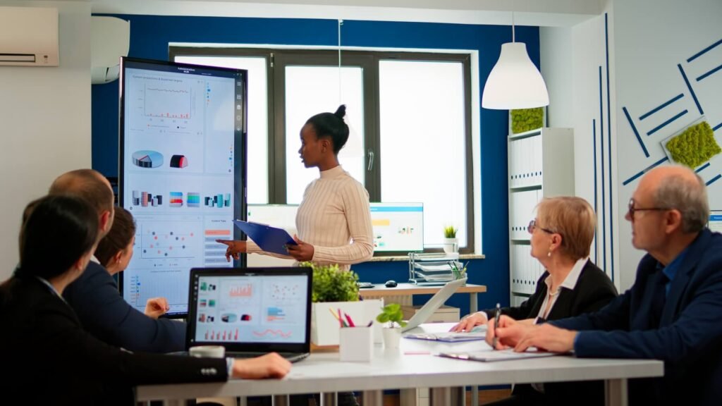 Presenter reviewing performance projections with the team on a dashboard screen