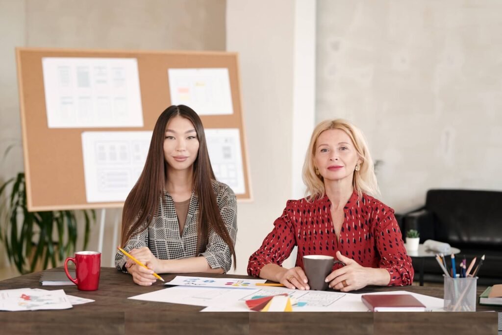 Two team members reviewing brand strategy materials at a desk